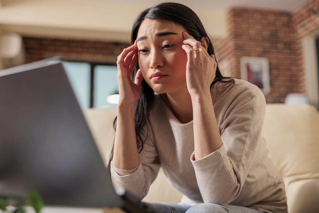 young asian woman having migraine and headache